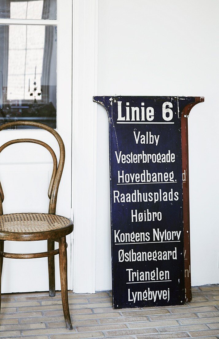 Thonet bentwood chair next to vintage tram sign listing Danish tram stops
