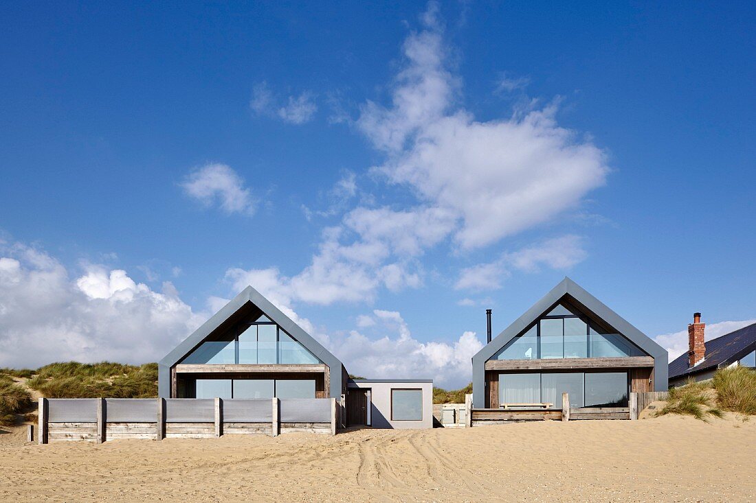Camber Sands Beach Houses, Rye, United Kingdom. Architect: Walker and Martin, 2014; View of houses looking up from the beach