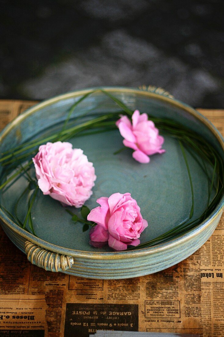 Roses and peonies in dish of water