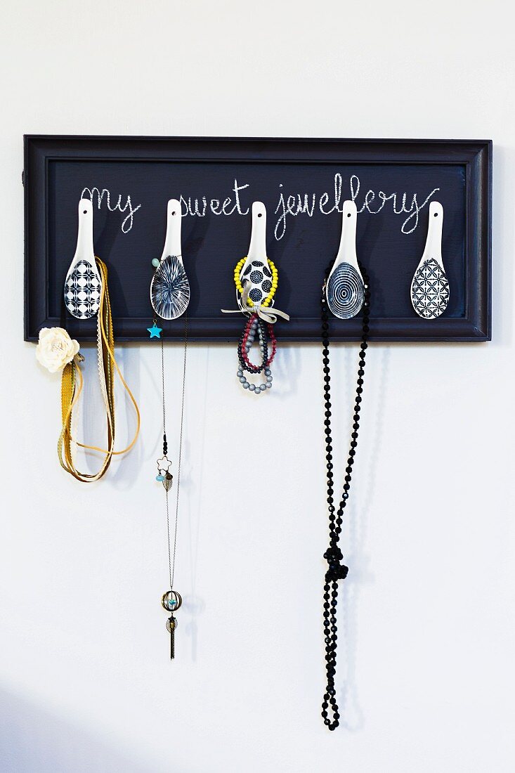 Hand-crafted jewellery rack with Chinese spoons as hooks mounted on wall