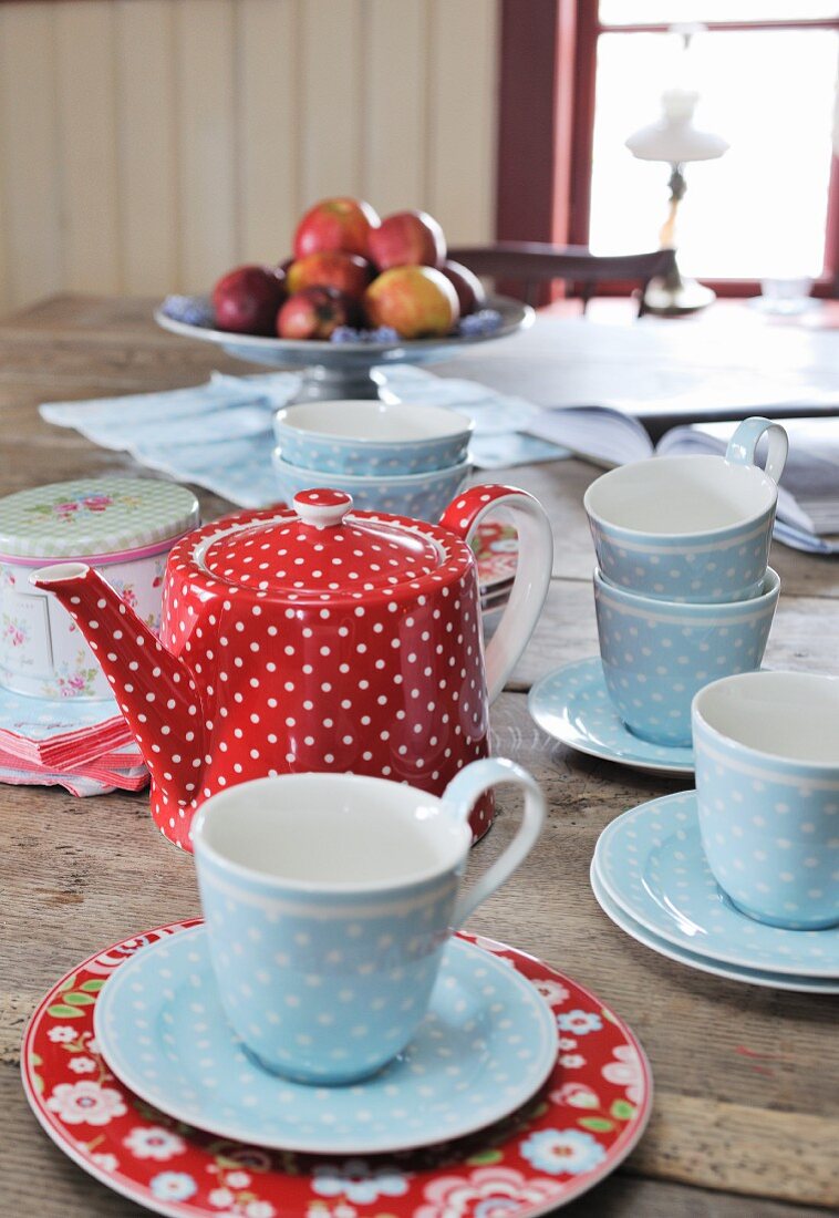 Rustic, red and blue polka-dot teacups and teapot