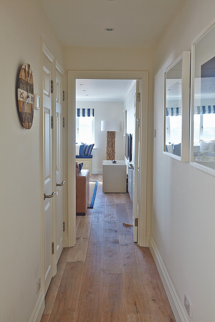 Hallway with wooden floor and decorative country-style wall clock