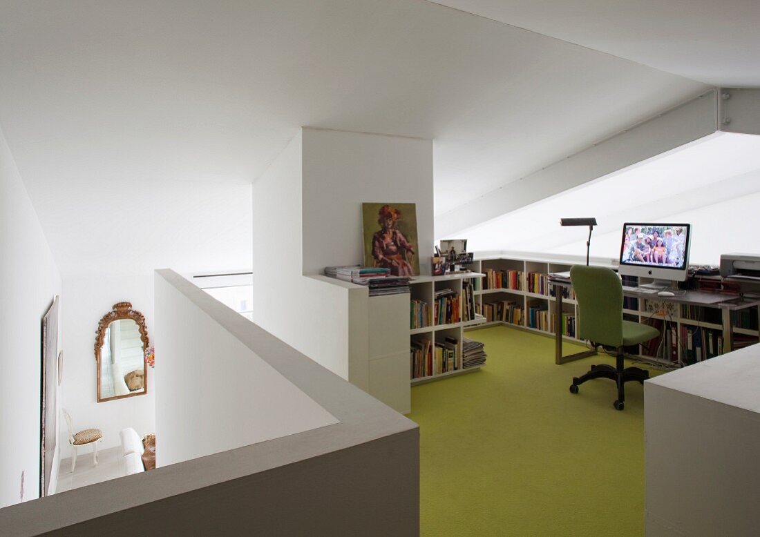 Workspace with half-height shelving and green floor on gallery