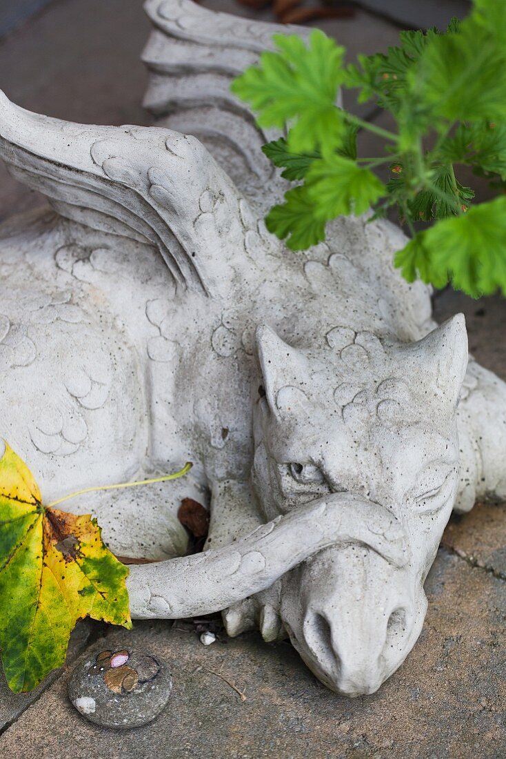 Stone dragon on garden wall