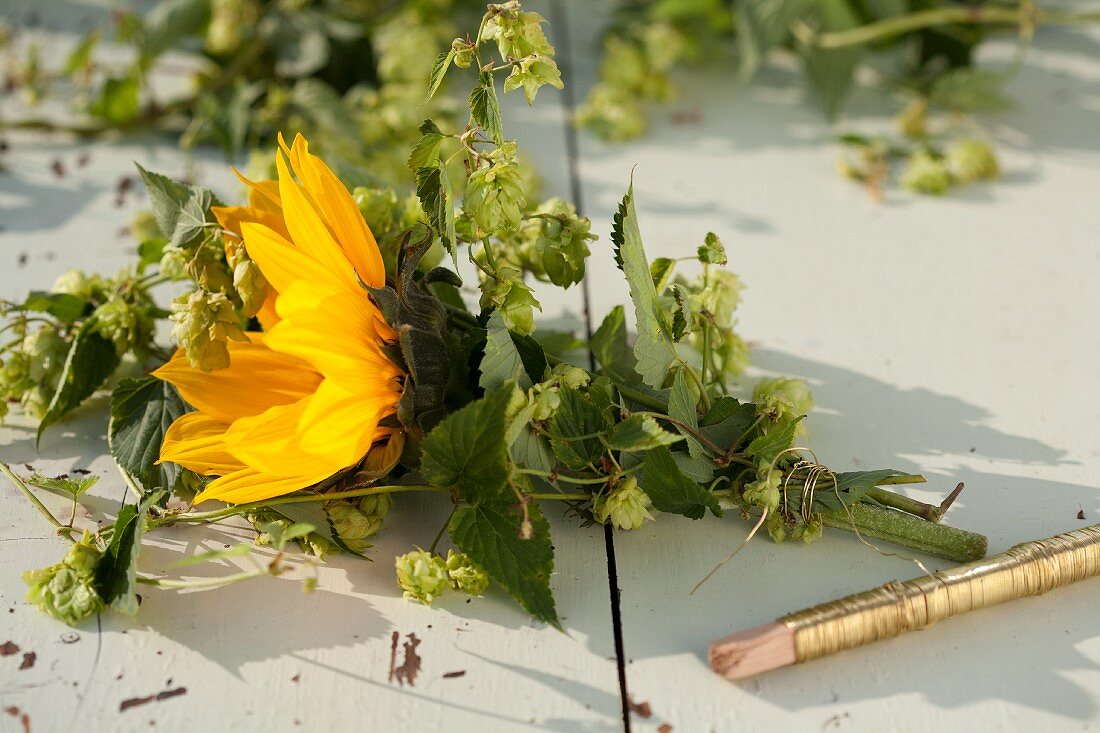 Tying sunflowers & hop tendrils with florists' wire