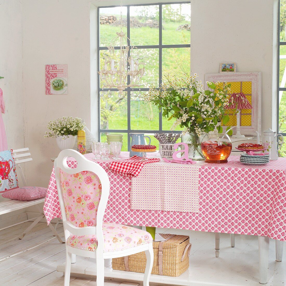 Spring bouquet on table with patterned tablecloth and place mats and vintage chair with country-house-style upholstery