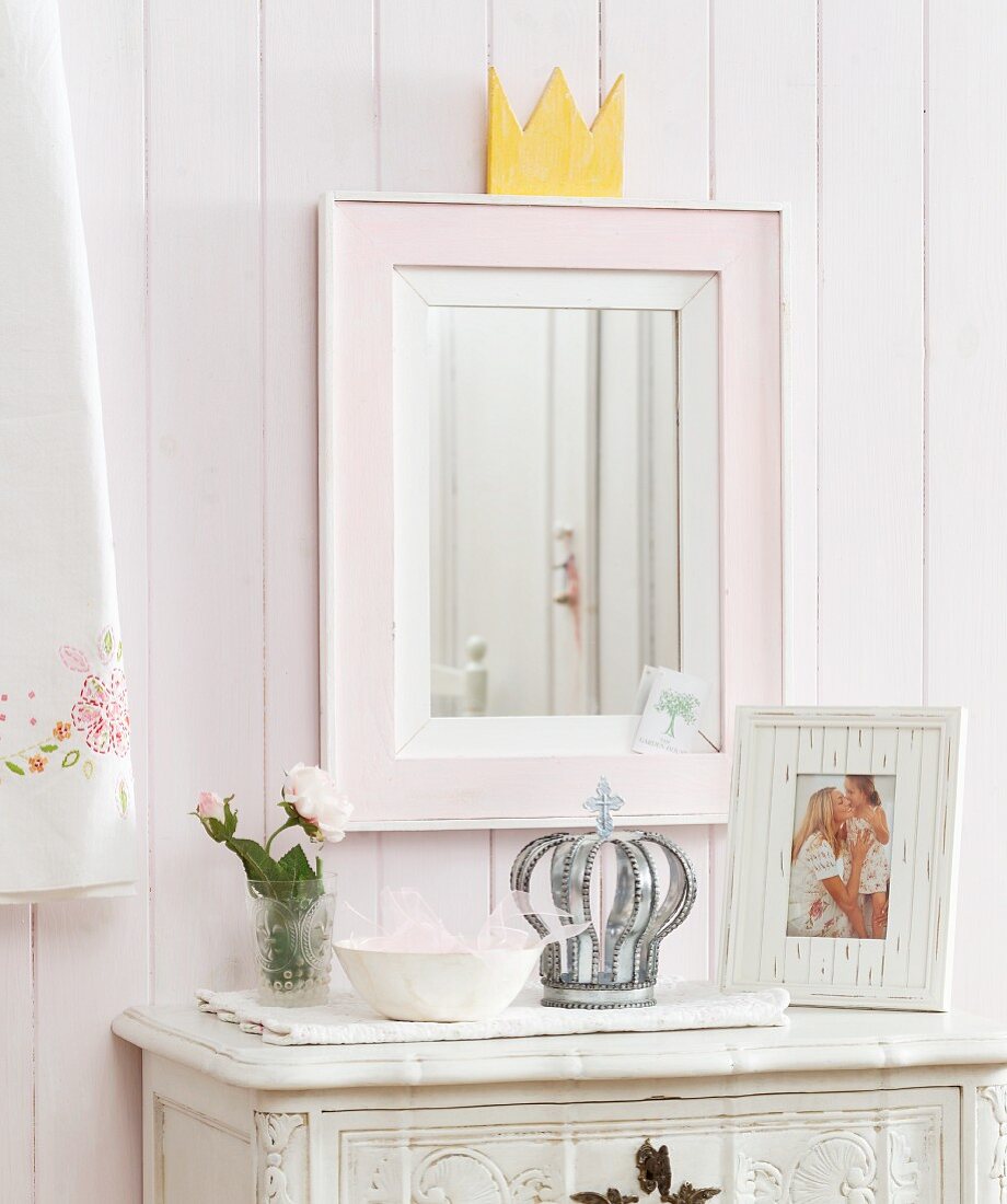 Mirror with hand-crafted crown on top of frame