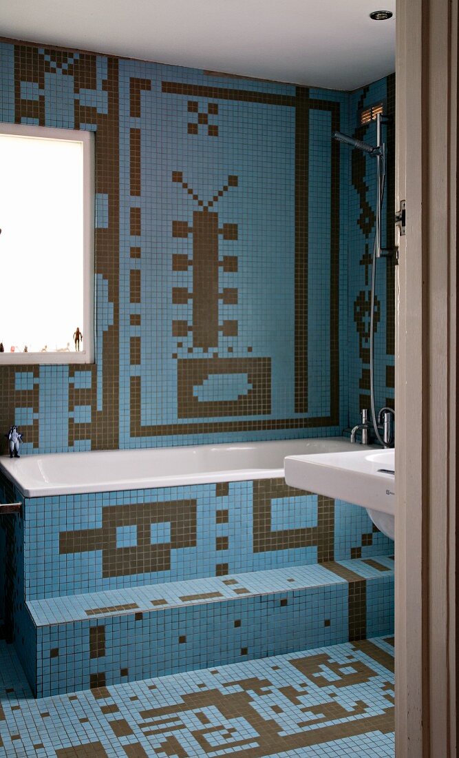 Bathroom tiled in imaginative patterns of blue and brown mosaic tiles