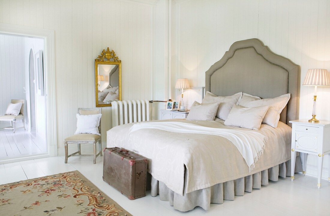 Shabby-chic bedroom in Norwegian manor house with white wood panelling
