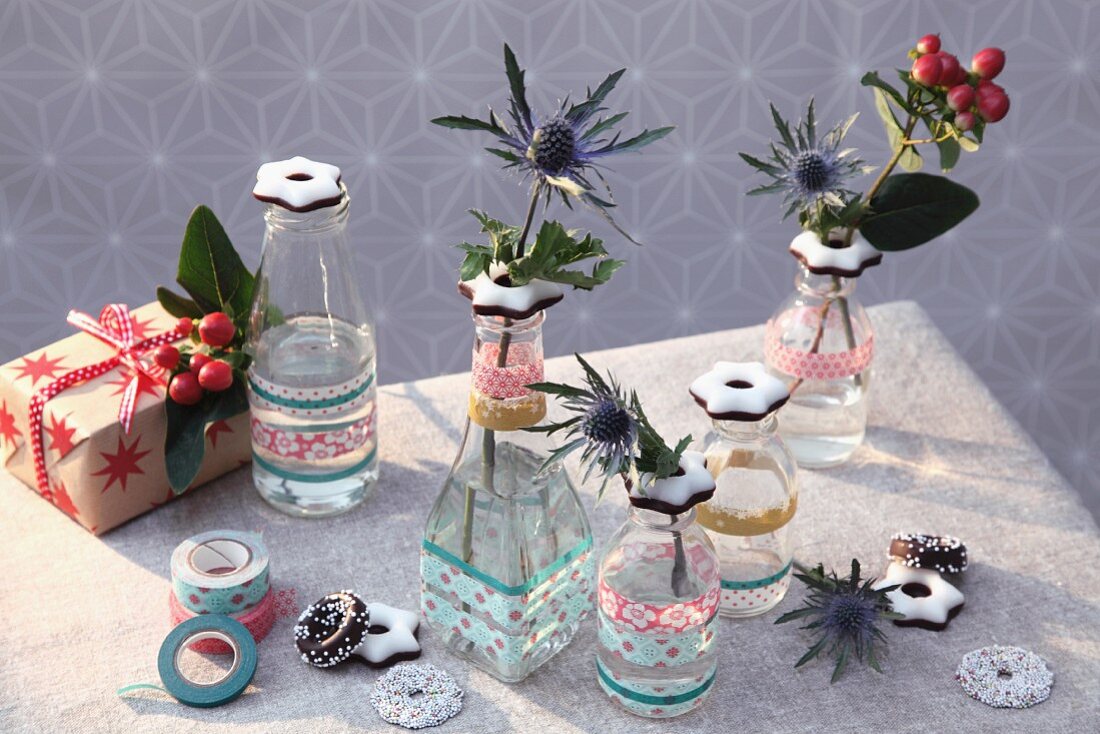 Bottles decorated with fondant stars and washi tape used as small, festive vases