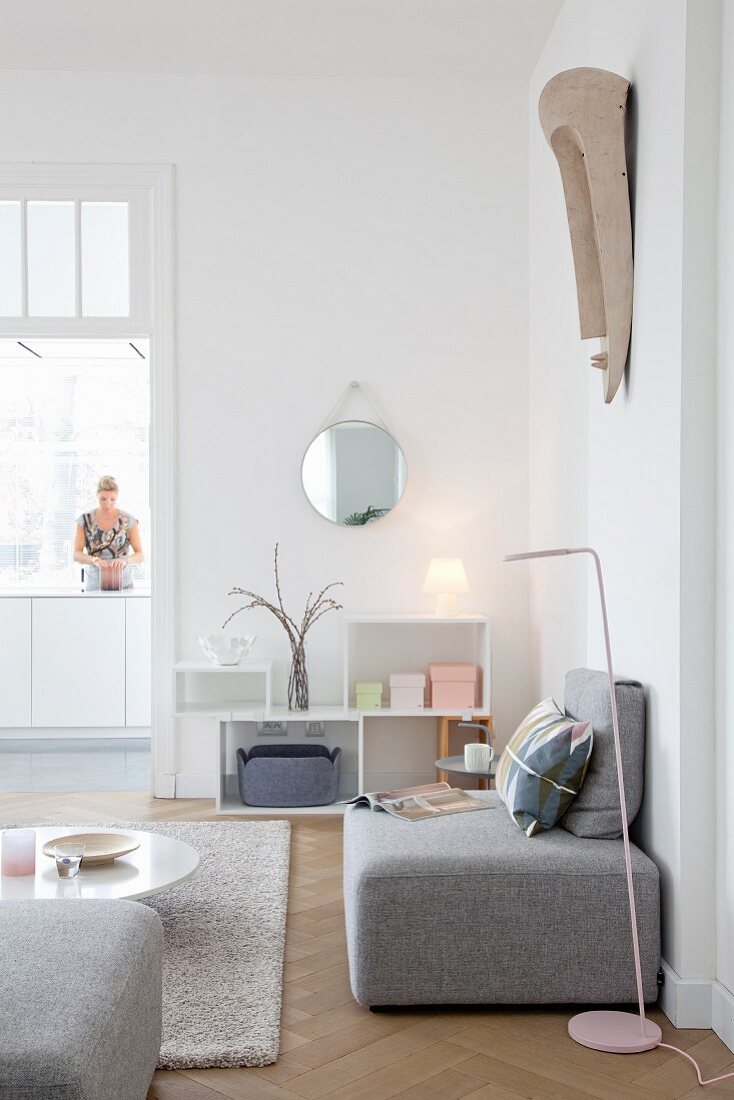 Grey sofa element in living room with view into kitchen