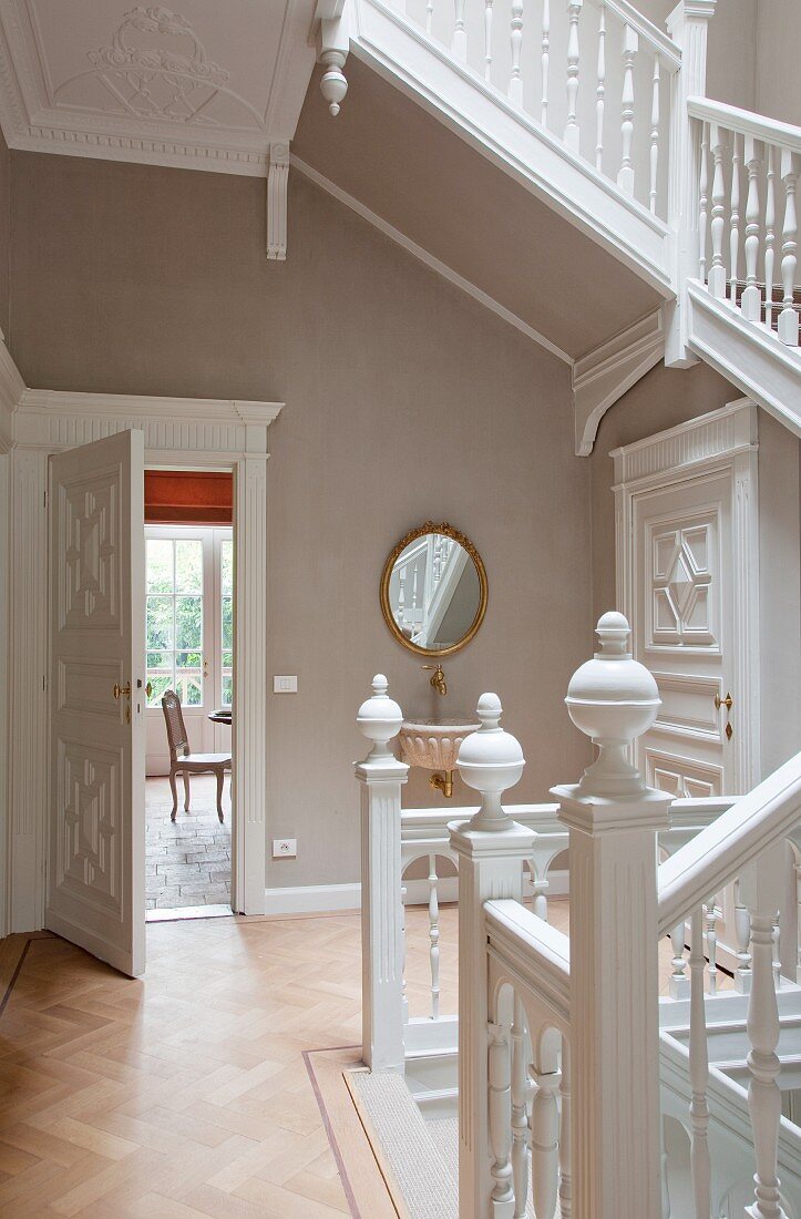 Open-plan staircase with carved balustrade in renovated house