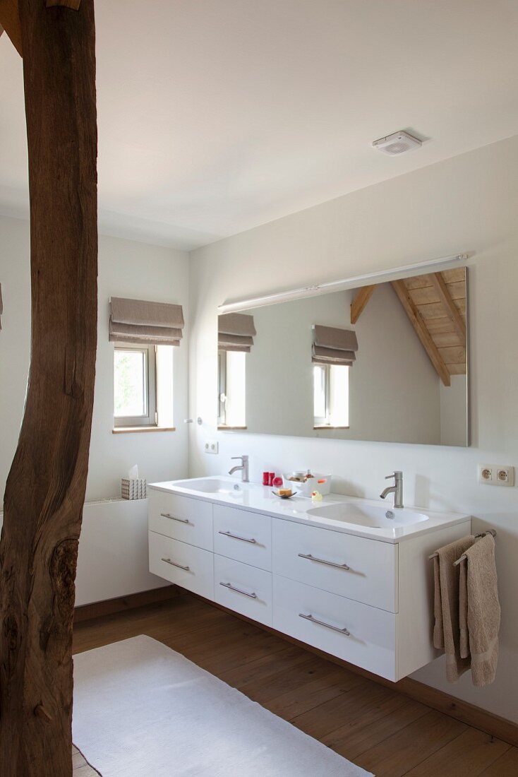 White washstand with drawers in modernised attic bathroom