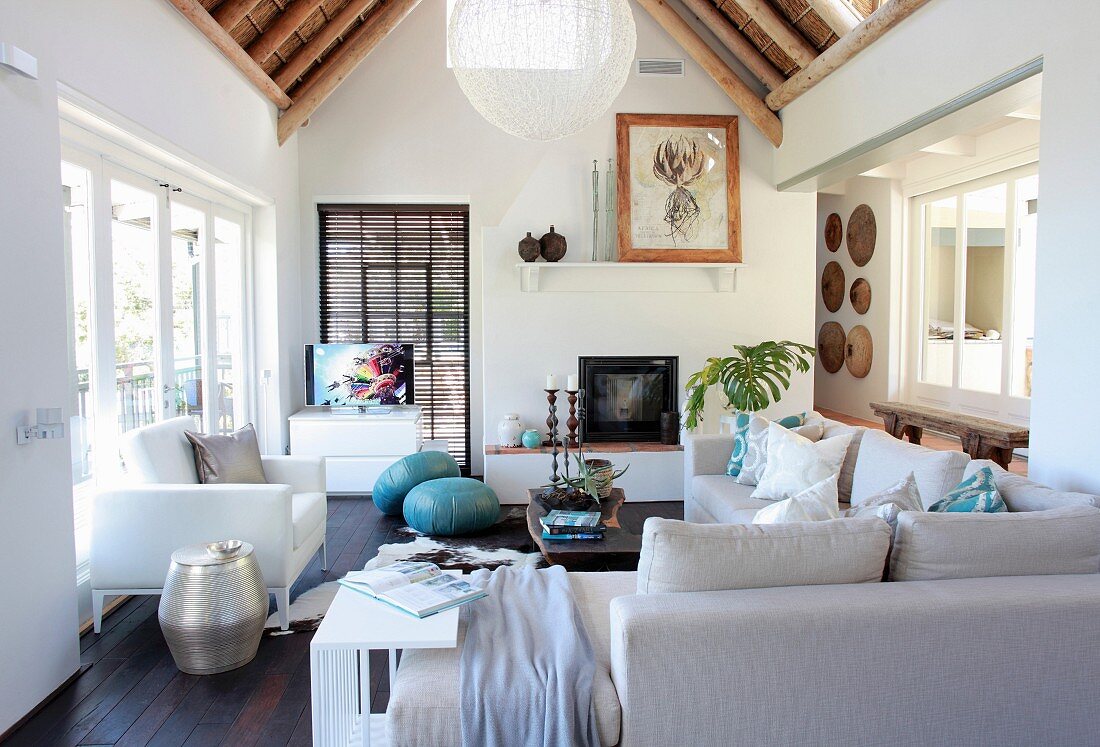 Pale sofa set in living room with partially exposed bamboo roof structure