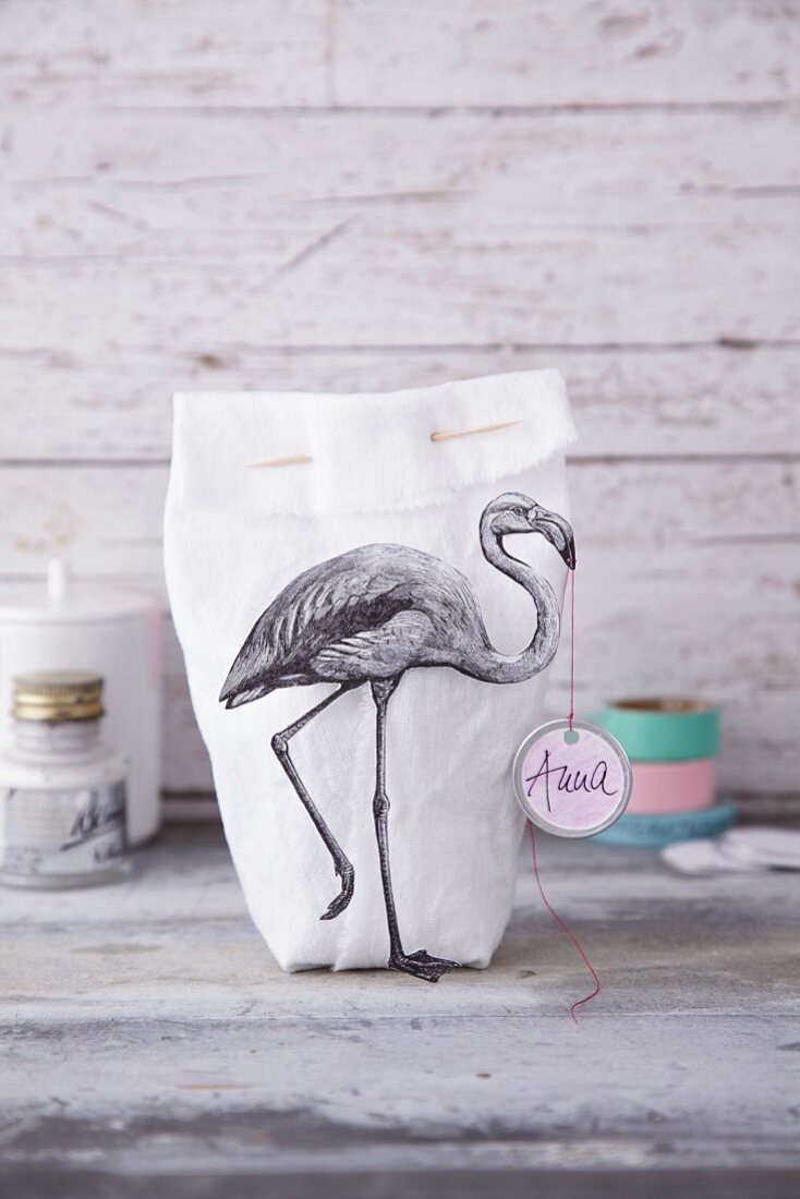 A fabric bag decorated with a flamingo print