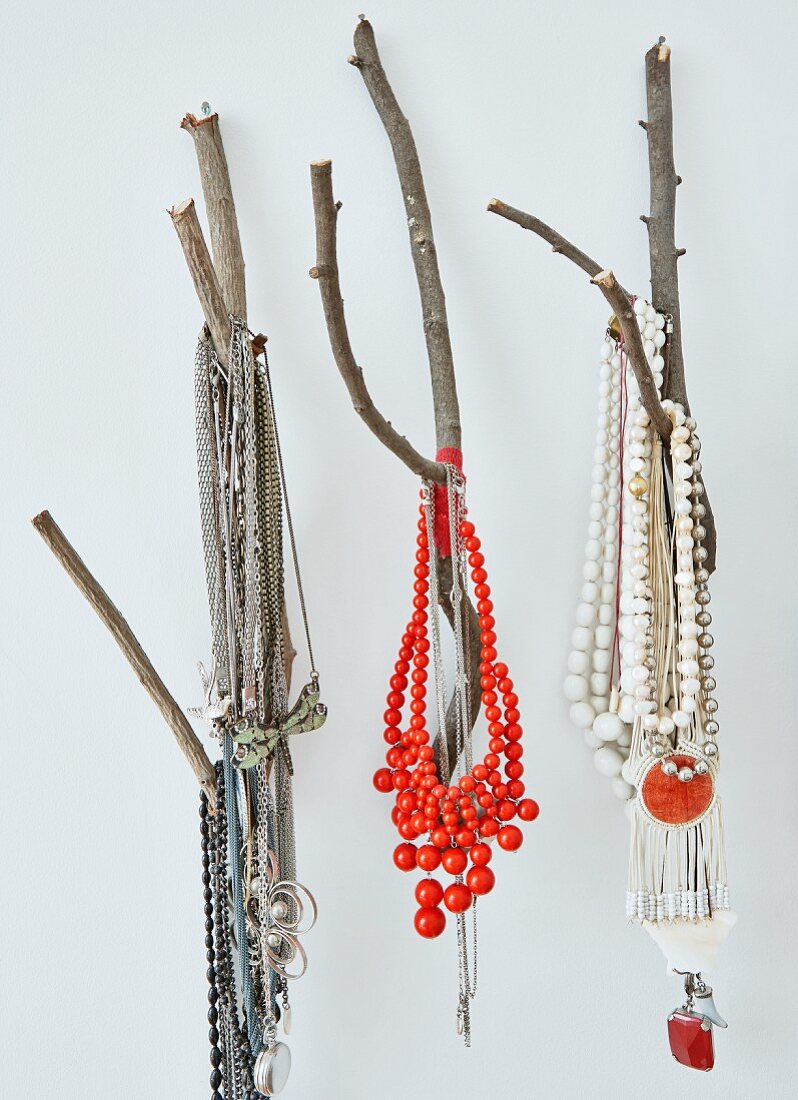 Necklaces of colourful beads hung from branches