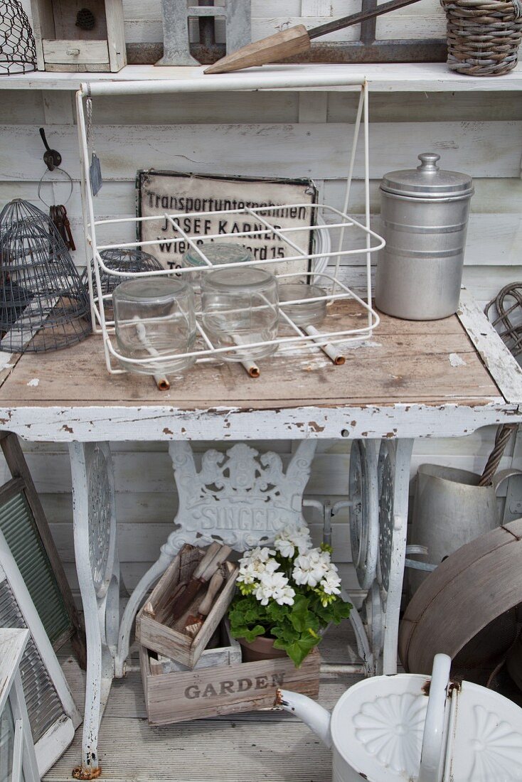 Sewing machine frame repurposed as table in garden shed