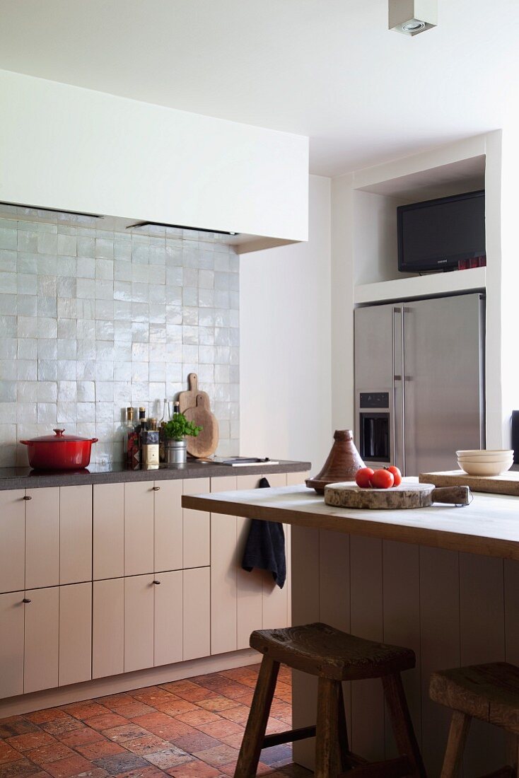 Rustic kitchen with terracotta floor tiles and glazed wall tiles