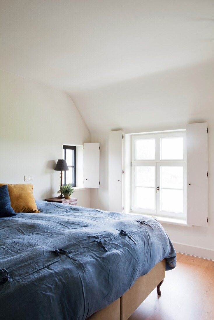 Folding shutters on windows of attic bedroom