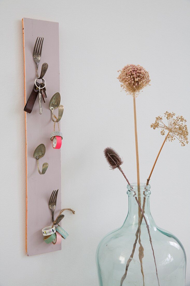 Key hanger hand-crafted from bent vintage cutlery and pastel wooden panel