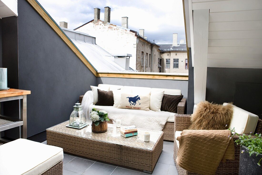 Wicker furniture in lounge area on roof terrace