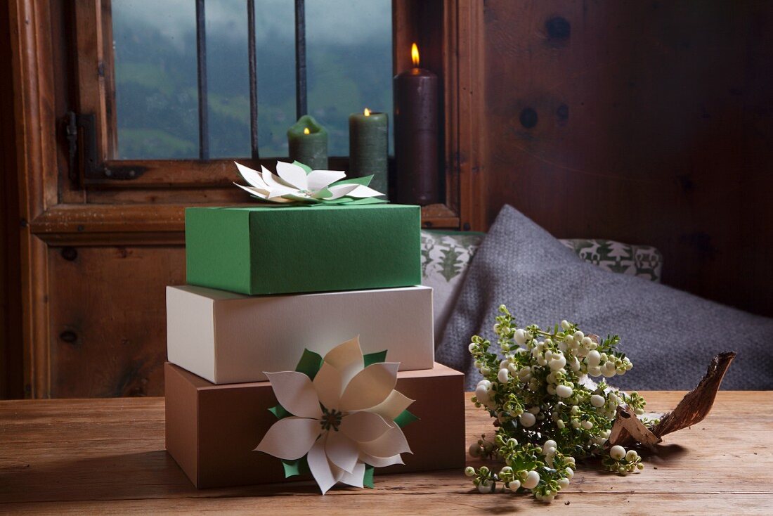 Hand-made festive paper flowers decorating gift boxes