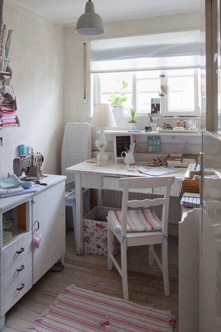 Flea-market furniture, desk, sideboard and sewing machine in small room