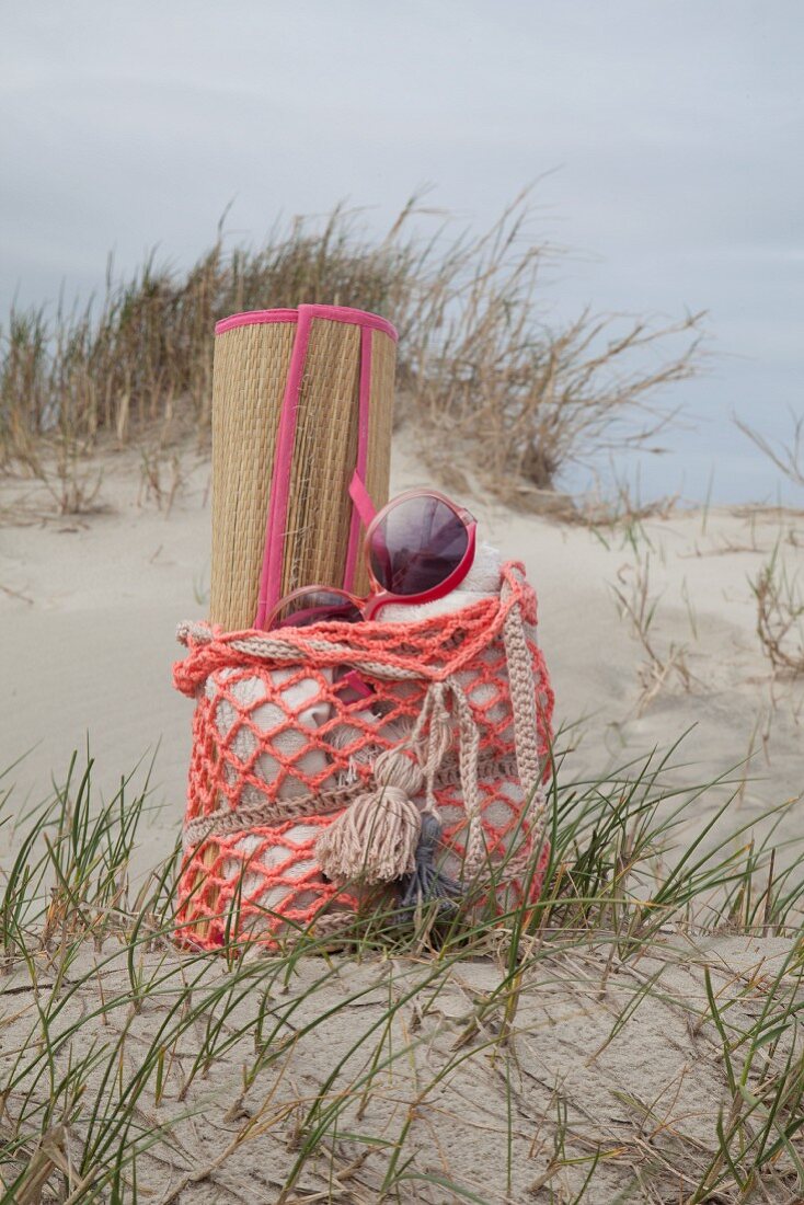 Straw beach mat in crocheted beach bag