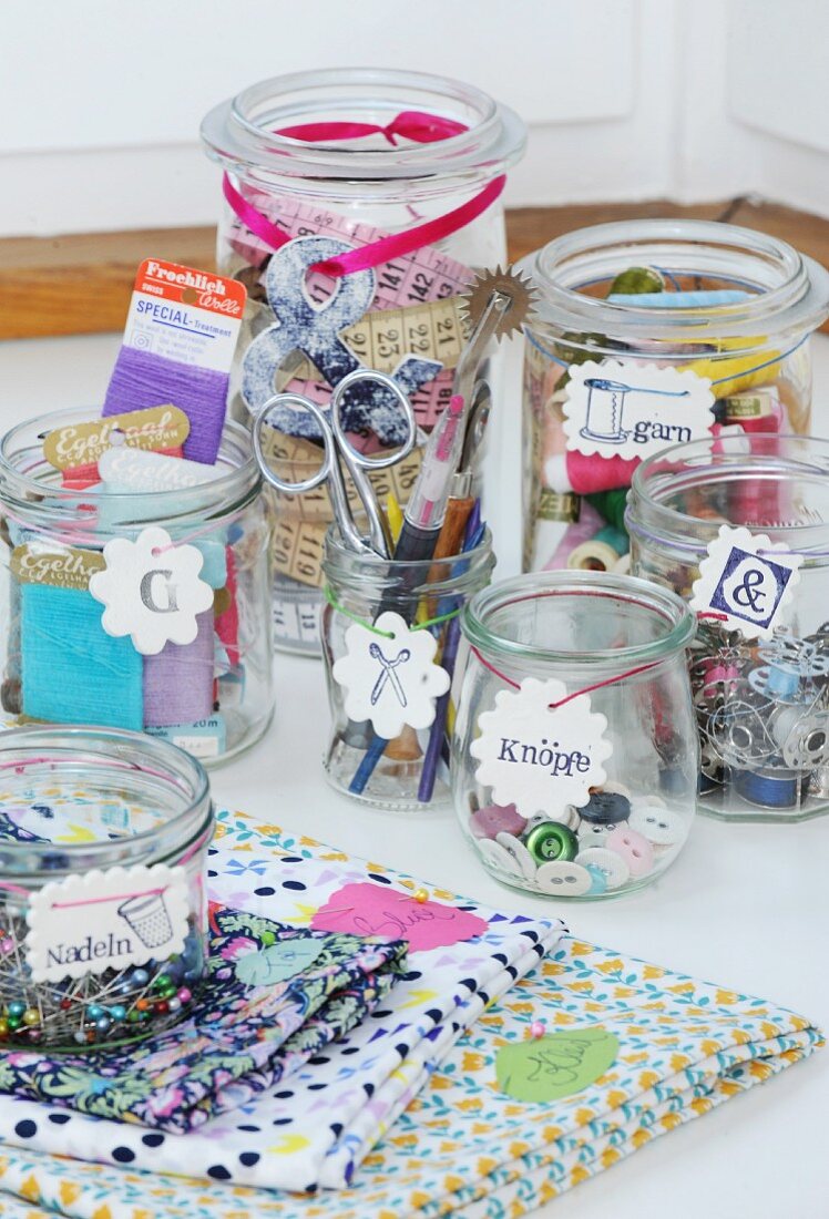 Sewing utensils in mason jars with labelled tags hand made from modelling compound