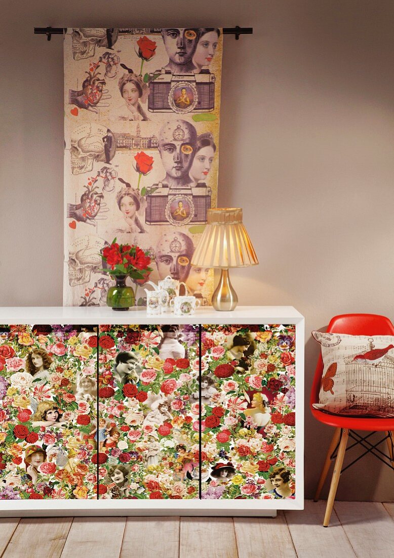Sideboard with floral doors, classic chair with red shell seat and long fabric wall hanging