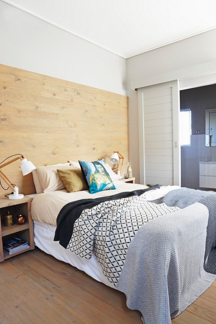 Partially wood-clad wall in bedroom
