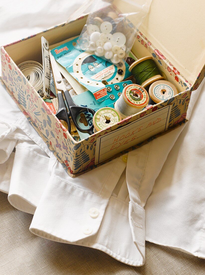 Sewing supplies in box with retro pattern