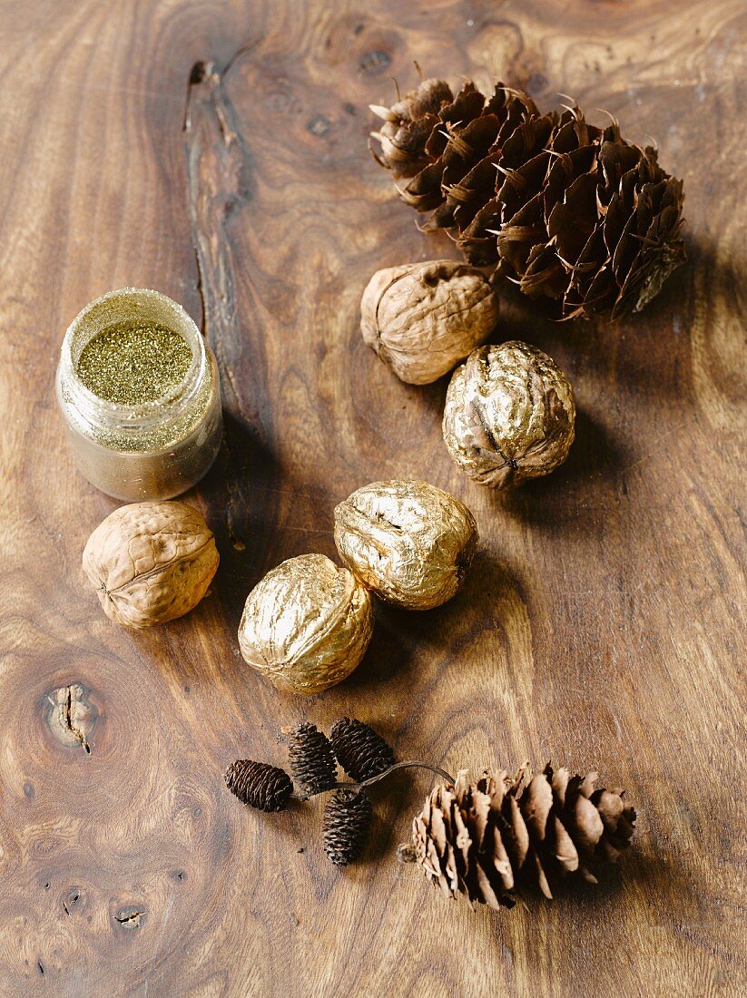 Walnuts, various pine cones and jar of gold powder