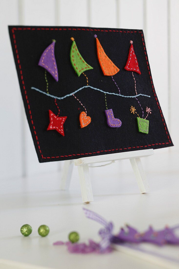 Hand-crafted felt artwork with festive motifs on bookstand