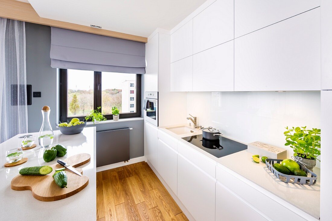 Open-plan white kitchen with island counter