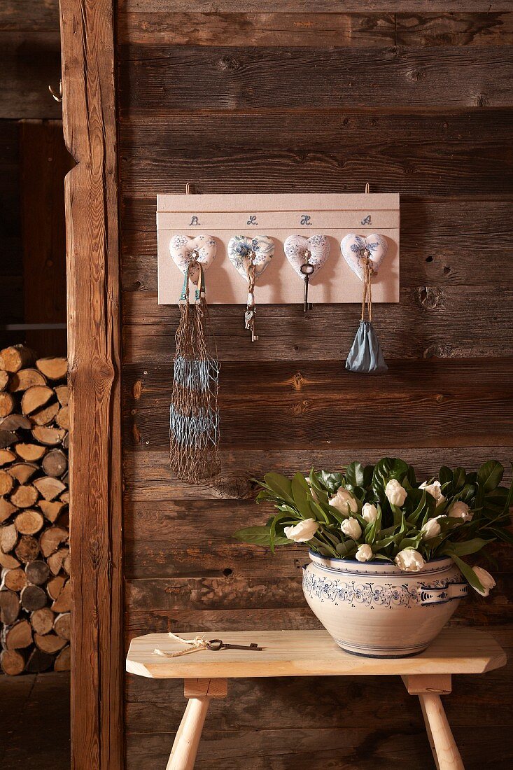 DIY key rack with love-heart ornaments on wooden wall