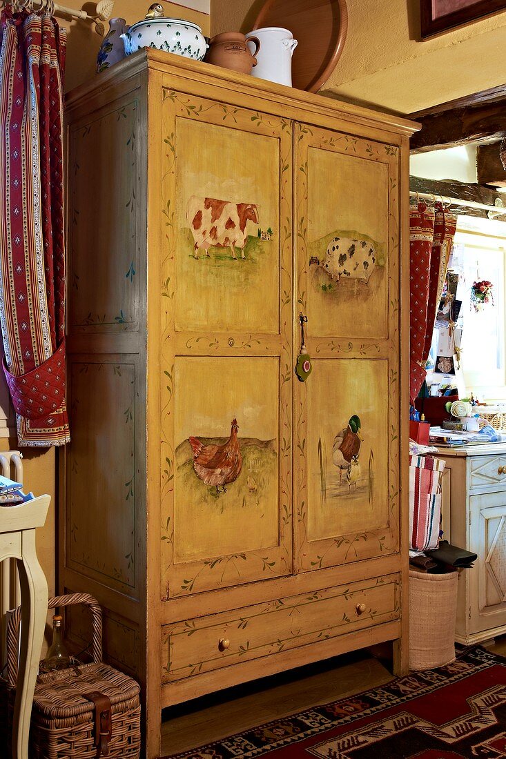 Old farmhouse wardrobe painted with animal motifs