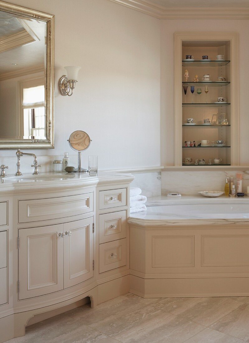 Elegant country-house bathroom with corner bathtub and fitted washstand