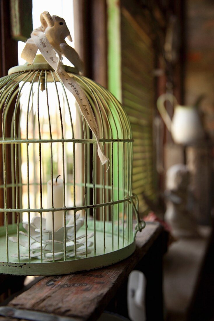 Flower-shaped candlestick in vintage birdcage