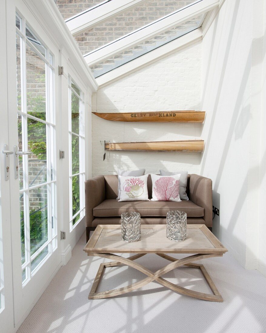 Sofa and coffee table in bright, narrow conservatory