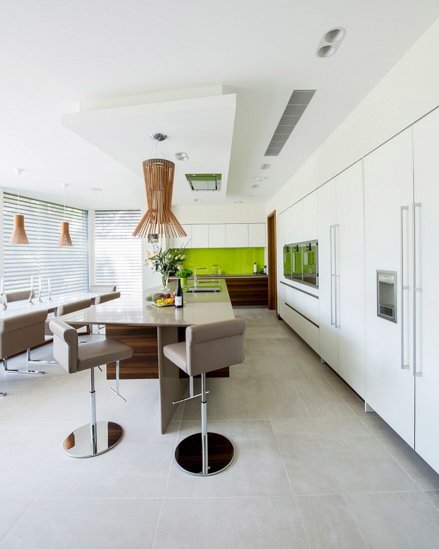 Modern kitchen-dining room with large kitchen counter and bar stools