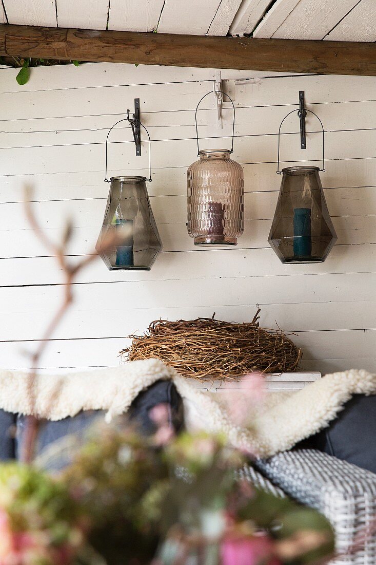 Lanterns hung on white-painted wooden wall