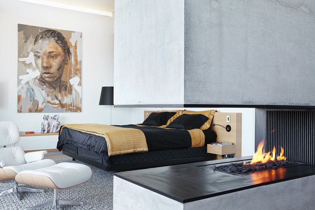 Concrete gas fireplace in modern bedroom
