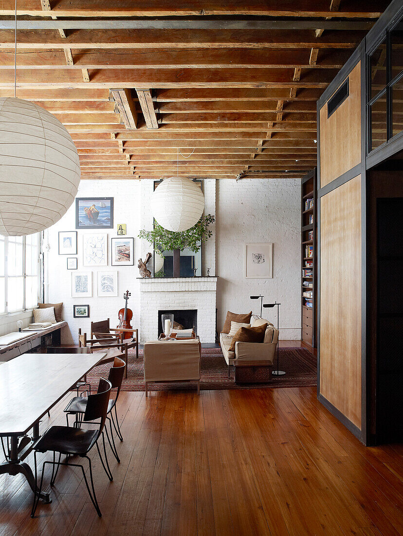 Wooden floor and wood-beamed ceiling in vintage-style open-plan interior