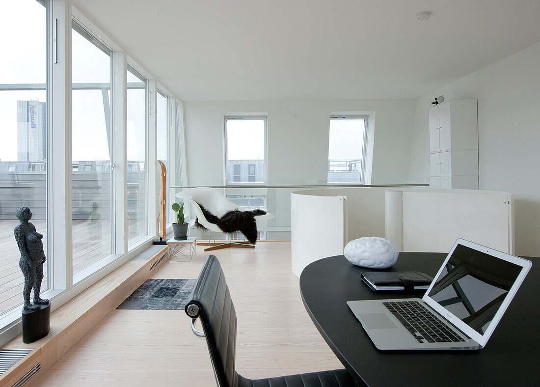 Study with glass wall overlooking roof terrace