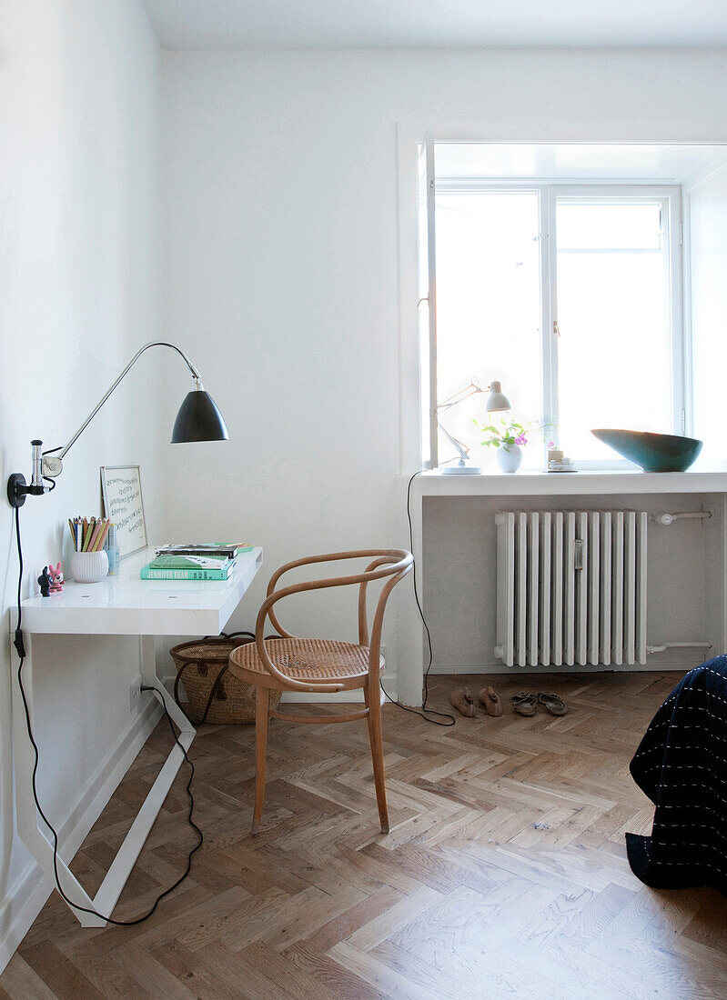 Designer chair at narrow desk in bedroom