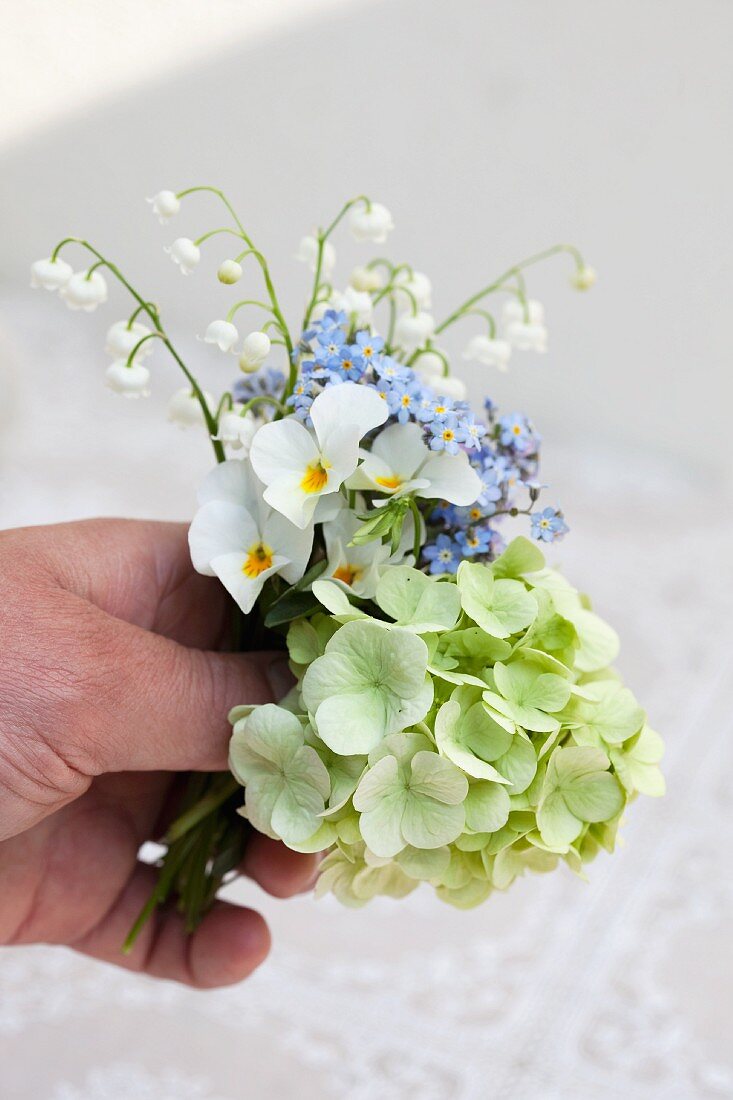 Spring posy of violas, lily of the valley, forget-me-nots & hydrangeas