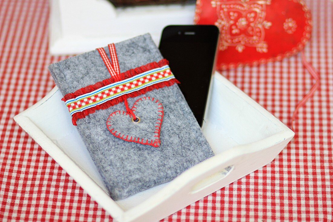 Hand-made felt mobile phone case decorated with ruffled ribbon and love-heart