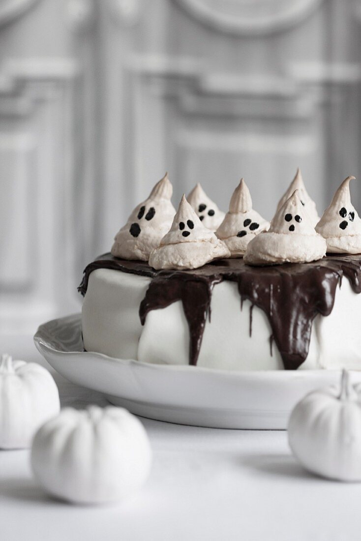 Halloween cake topped with meringue ghosts