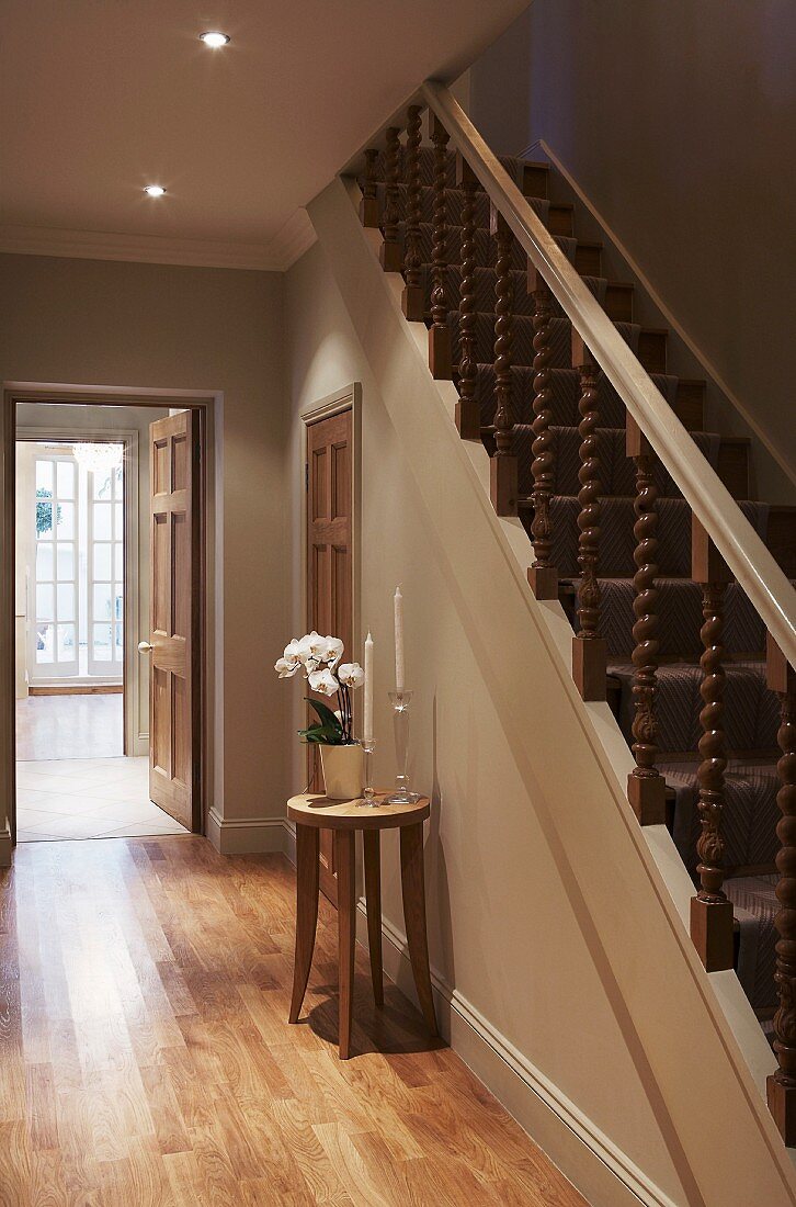 Hallway in natural shades with traditional, wooden staircase